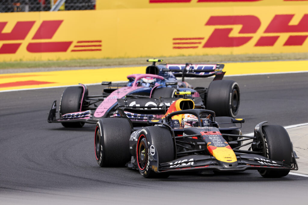 Yuki Tsunoda drives the Red Bull F1 car with an Alpine in pursuit