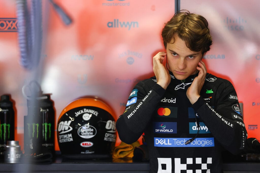 Oscar Piastri covering his ears in the McLaren garage during a session at the Hungarian Grand Prix