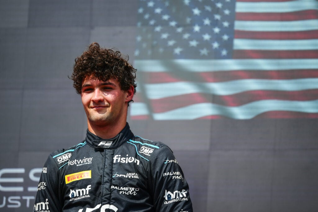 Formula 2 driver Jak Crawford smiles on the podium