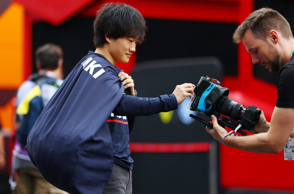 Yuki Tsunoda of Red Bull signs an autograph