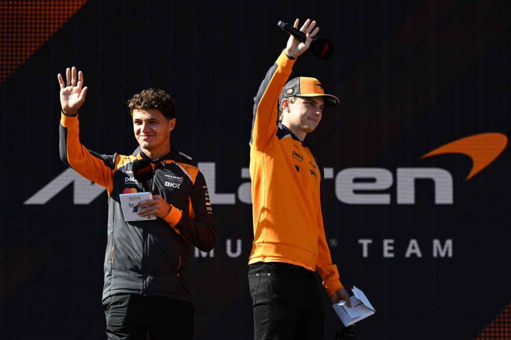 McLaren drivers Lando Norris and Oscar Piastri greet fans on stage at the 2025 Dutch Grand Prix