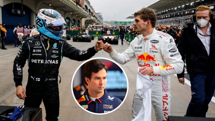 Valtteri Bottas and Max Verstappen bumping fists in the pit lane after a race as Sergio Perez stands in the Red Bull F1 garage at the 2024 Monaco G...