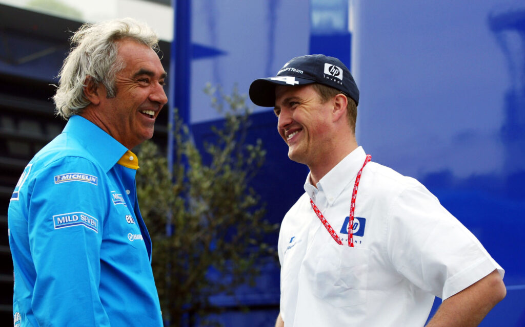 Renault team principal Flavio Briatore and Williams driver Ralf Schumacher share a joke at the 2003 Formula 1 Austrian Grand Prix