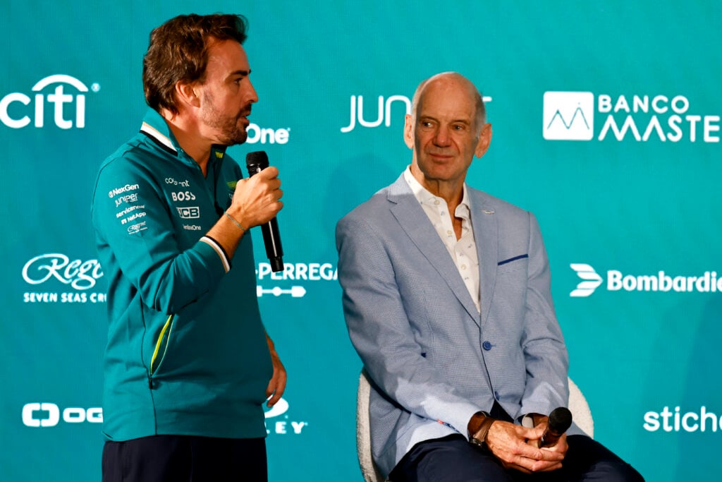 Aston Martin driver Fernando Alonso speaking on stage alongside technical director Adrian Newey at Adrian Newey's press conference announcing his move from Red Bull