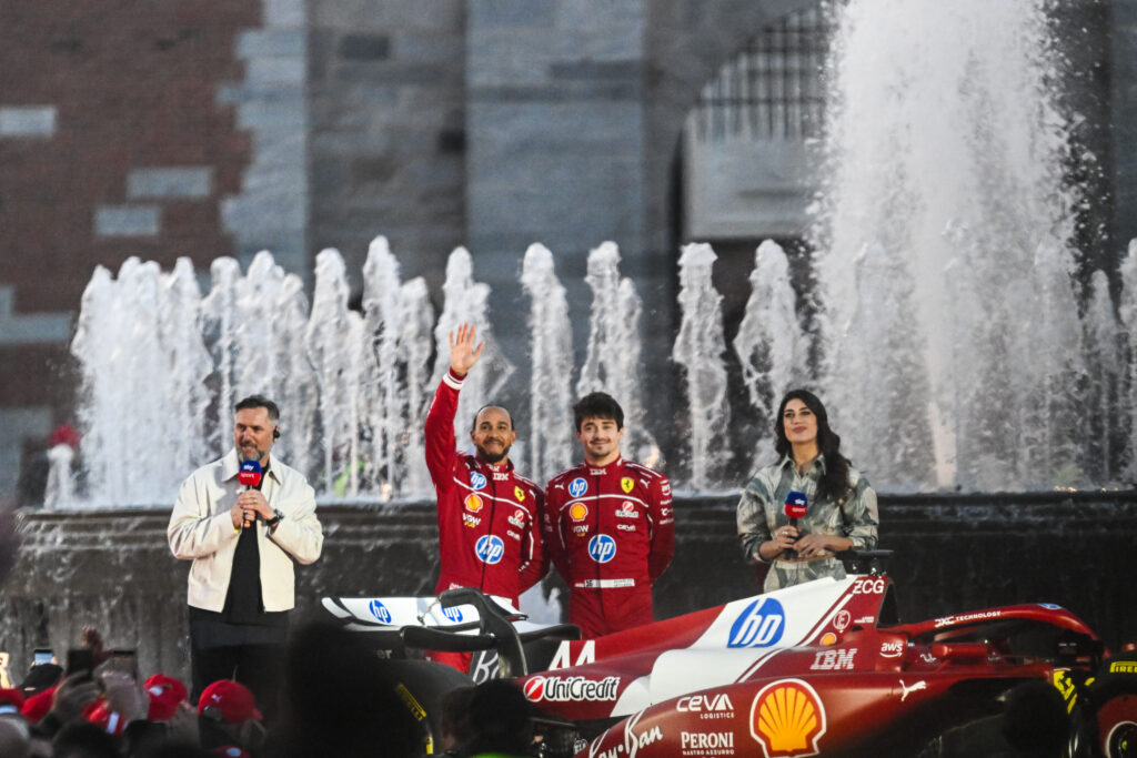 Lewis Hamilton waves to the fans at a Ferrari event