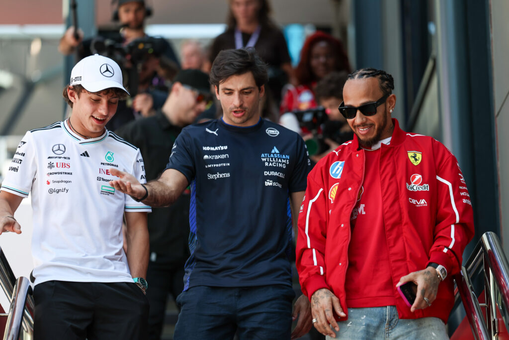 Mercedes driver Andrea Kimi Antonelli (left), Williams driver Carlos Sainz (centre) and Ferrari driver Lewis Hamilton (right) walking down the stairs at the 2025 Formula 1 Australian Grand Prix