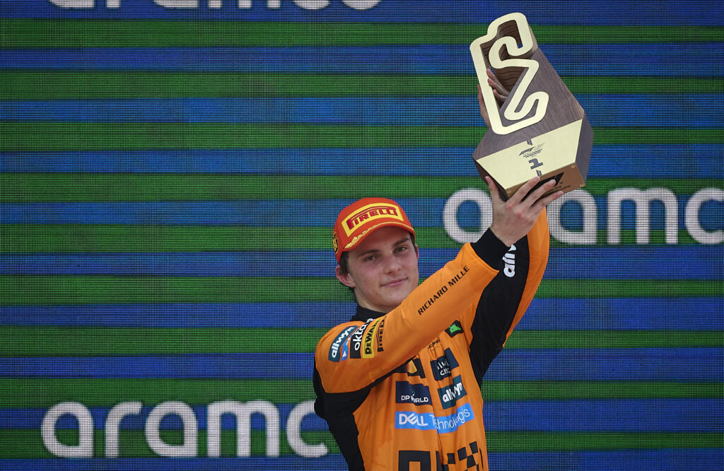 McLaren driver Oscar Piastri holding his trophy aloft on the podium at the 2025 Formula 1 Spanish Grand Prix