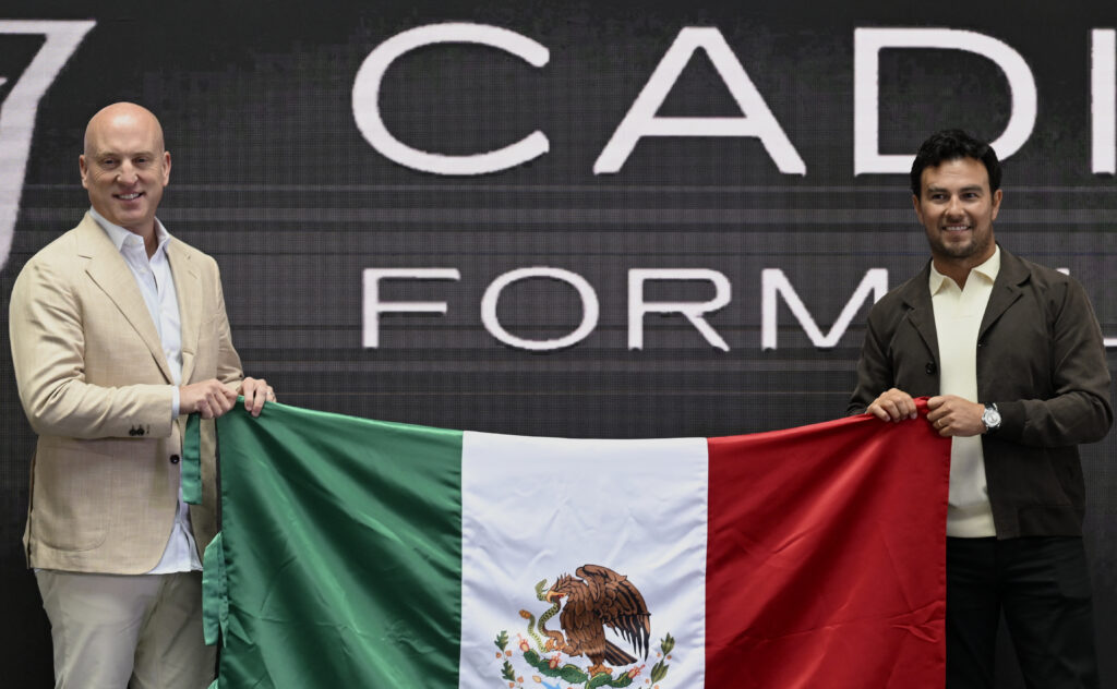 TWG Motorsports CEO Dan Towriss (left) and Cadillac driver Sergio Perez (right) holding a Mexican flag at a Cadillac press event