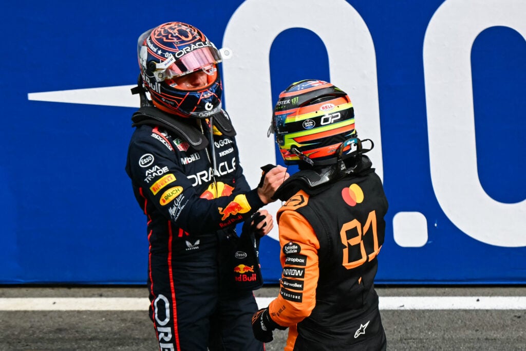 Red Bull Racing driver Max Verstappen (left) and McLaren driver Oscar Piastri (right) shaking hands after the 2025 Formula 1 Dutch Grand Prix