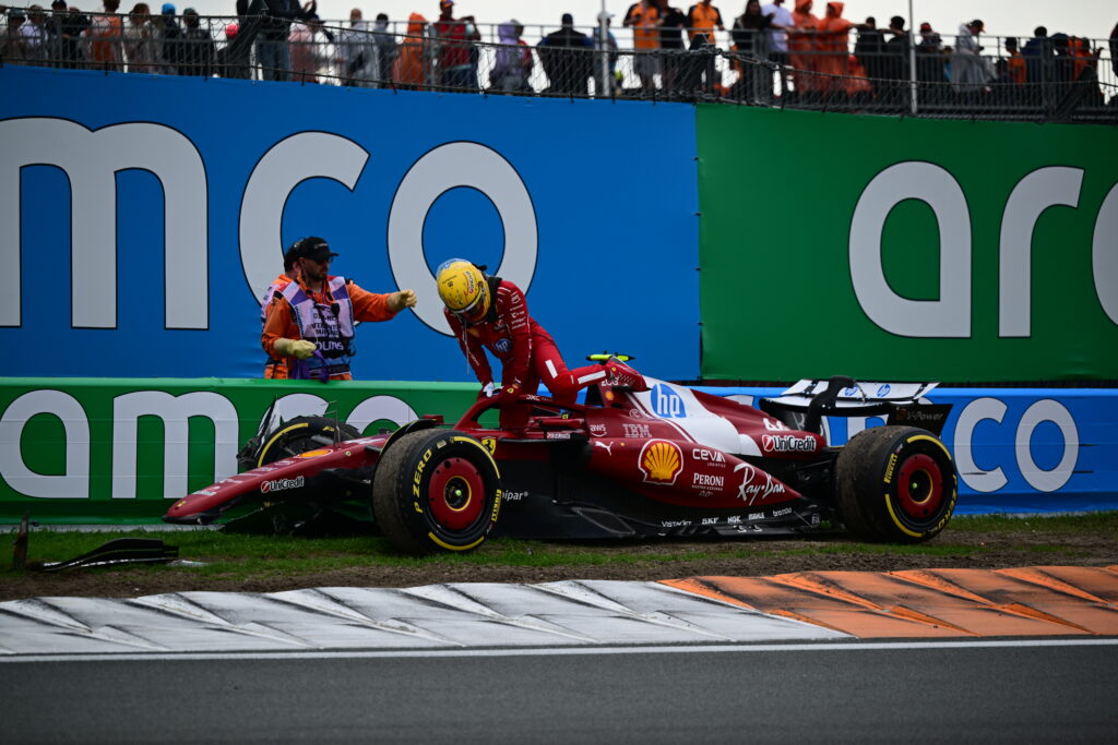 Ferrari driver Lewis Hamilton climbing out of his car after crashing at the 2025 Formula 1 Dutch Grand Prix