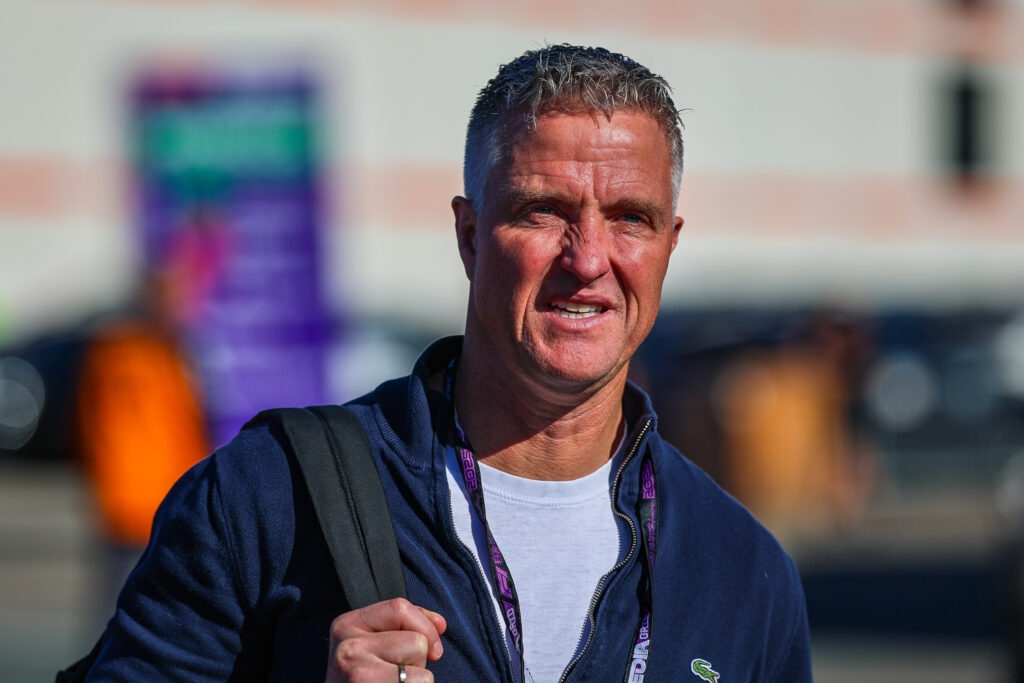 Ralf Schumacher wearing a backpack and walking through the paddock at the 2025 Formula 1 Dutch Grand Prix