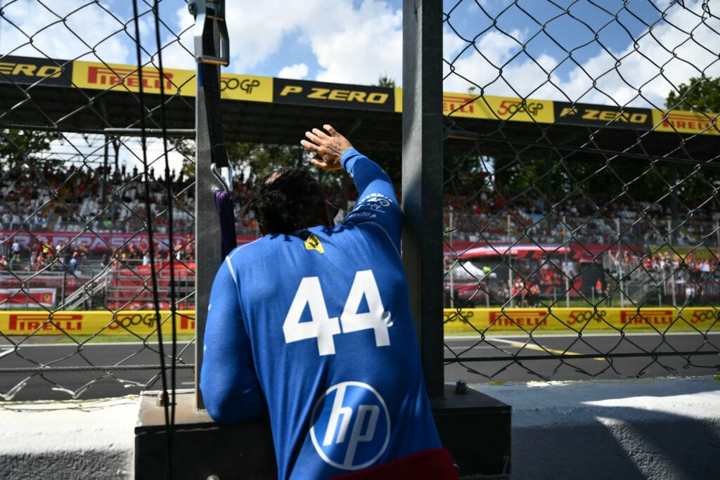 Lewis Hamilton of Ferrari waves to the fans