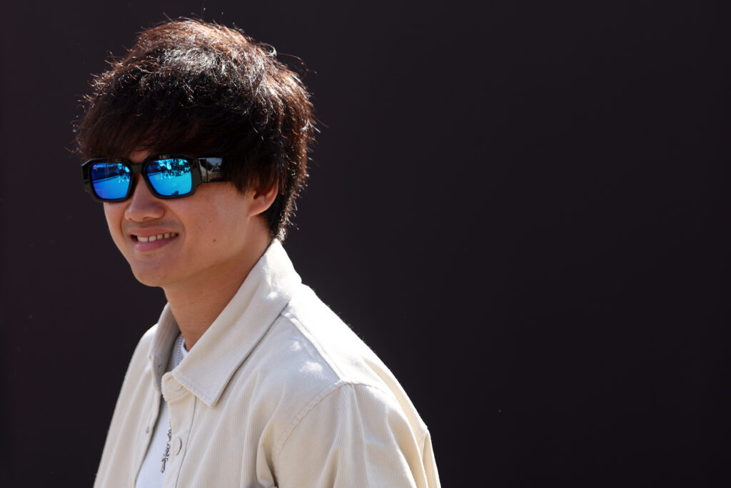 Yuki Tsunoda of Red Bull Racing looks on in the Paddock