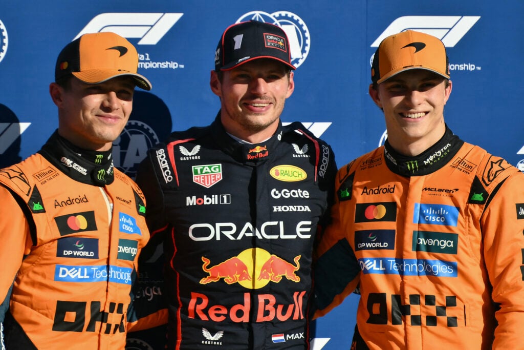 Lando Norris, Max Verstappen and Oscar Piastri smile for the camera after the 2025 Italian Grand Prix qualifying session