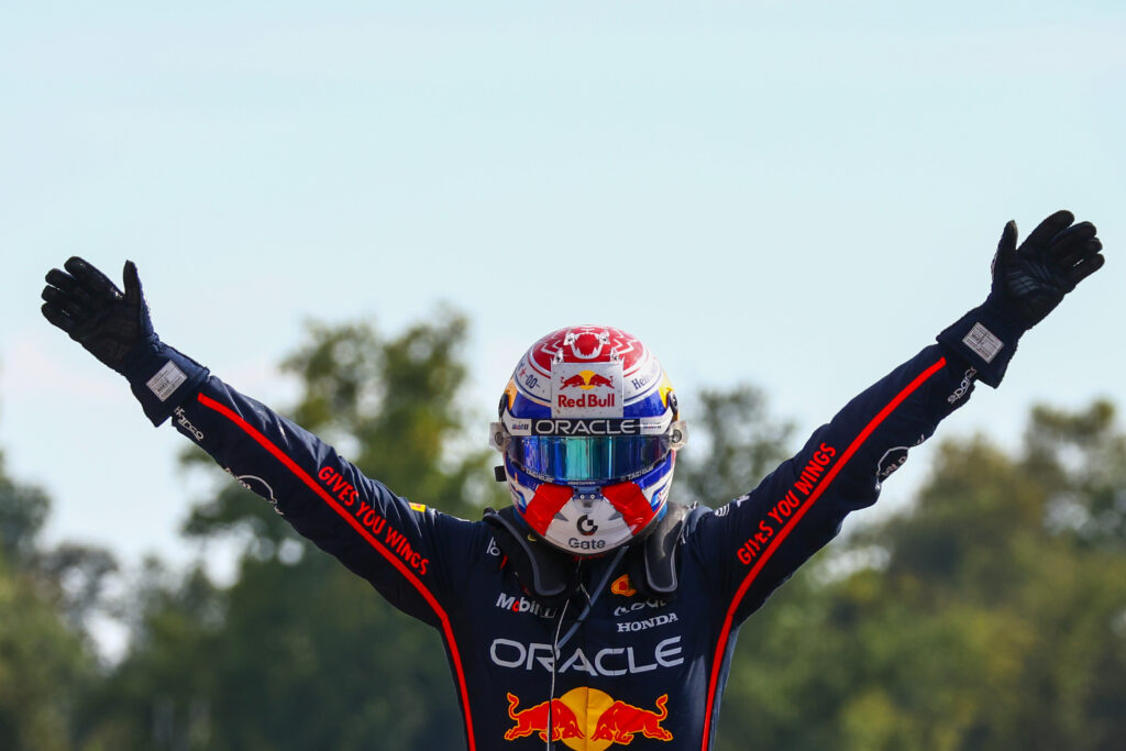 Red Bull Racing driver Max Verstappen with his arms aloft celebrating winning the 2025 Formula 1 Italian Grand Prix