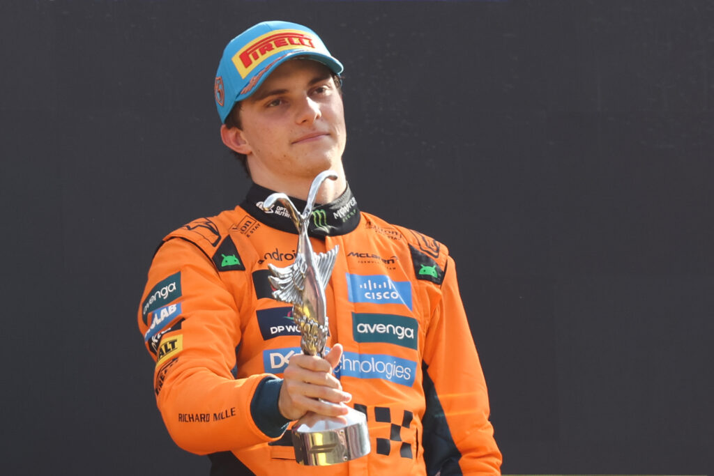McLaren driver Oscar Piastri holding his third place trophy on the podium at the 2025 Formula 1 Italian Grand Prix