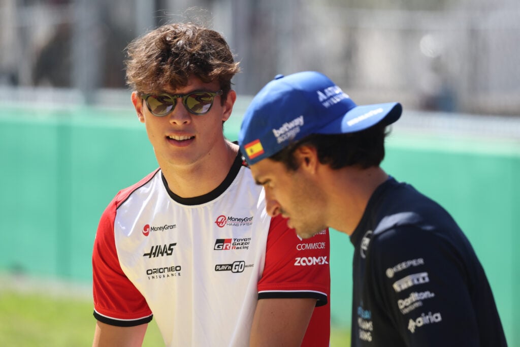 Haas driver Oliver Bearman speaks to Carlos Sainz of Williams before the 2025 F1 Italian Grand Prix at Monza
