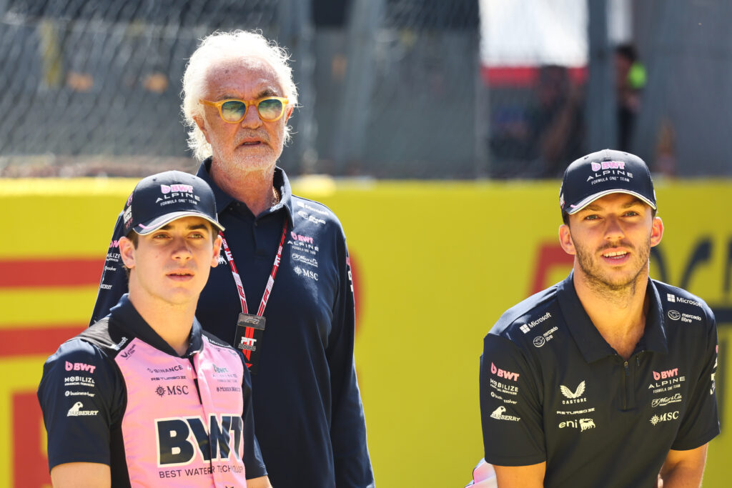 Alpine drivers Franco Colapinto and Pierre Gasly pose with executive adviser Flavio Briatore on the Monza grid before the 2025 F1 Italian Grand Prix