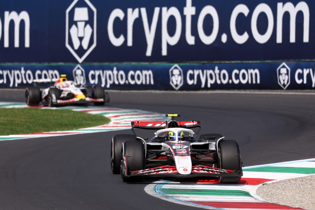Haas driver Oliver Bearman leading a Racing Bulls car through a chicane at the 2025 Formula 1 Italian Grand Prix