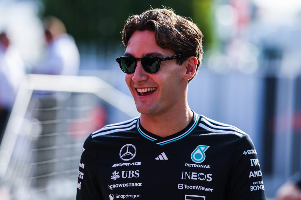 George Russell of Mercedes smiles in the Italian Grand Prix paddock