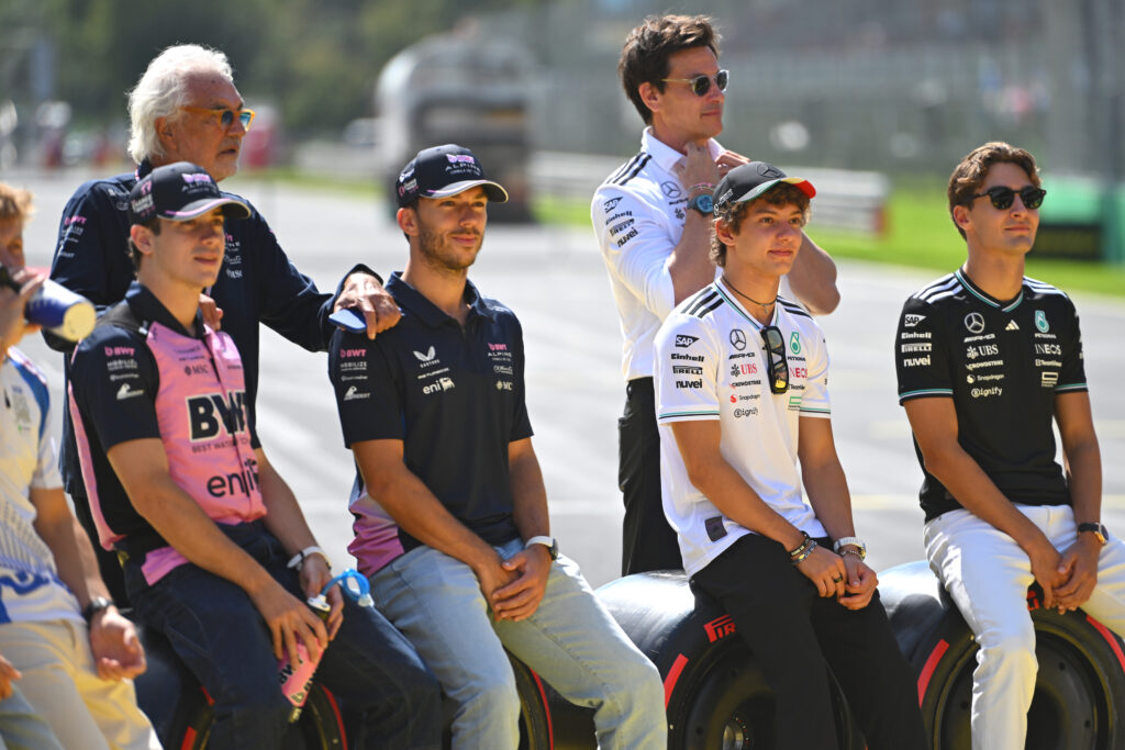 Alpine's Flavio Briatore, Franco Colapinto and Pierre Gasly pose for a picture with Mercedes' Toto Wolff, Kimi Antonelli and George Russell on the Monza grid before the 2025 F1 Italian Grand Prix