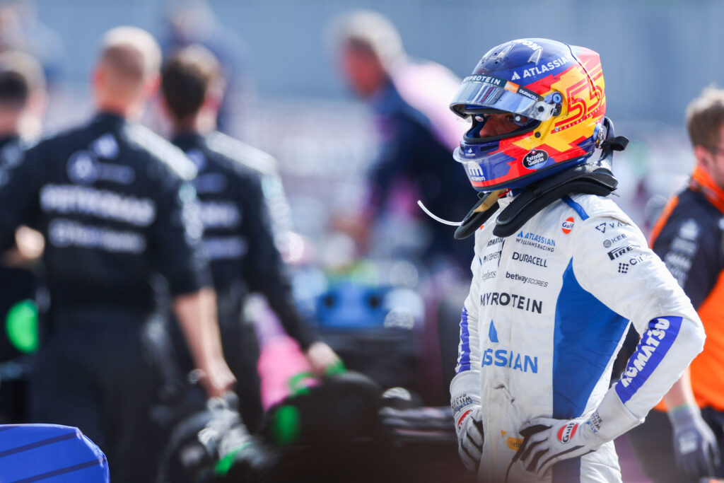 Williams driver Carlos Sainz in his race suit with his hands on his hips at the 2025 Formula 1 Italian Grand Prix