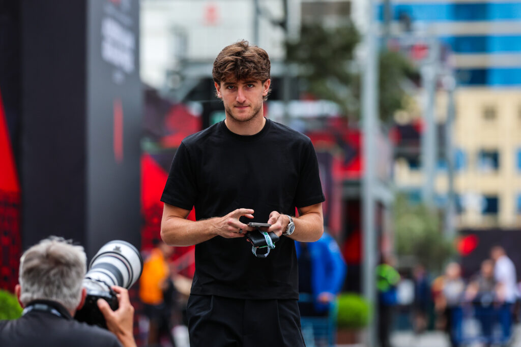 Alpine reserve driver Jack Doohan walks through the Baku paddock during practice for the 2025 F1 Azerbaijan Grand Prix
