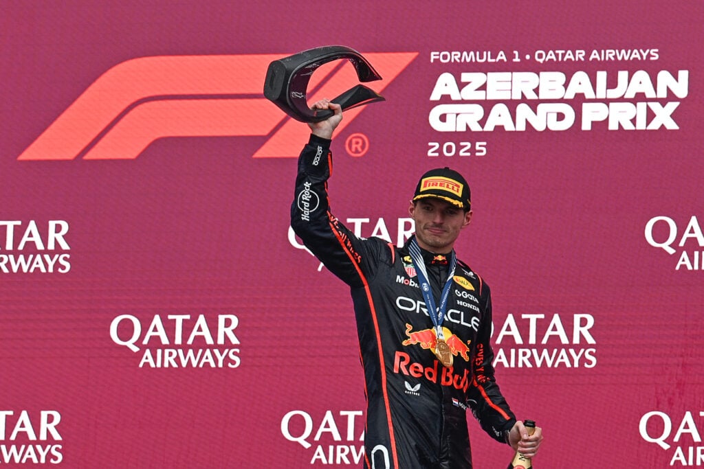 Red Bull driver Max Verstappen celebrates with his trophy on the Baku podium after winning the 2025 F1 Azerbaijan Grand Prix