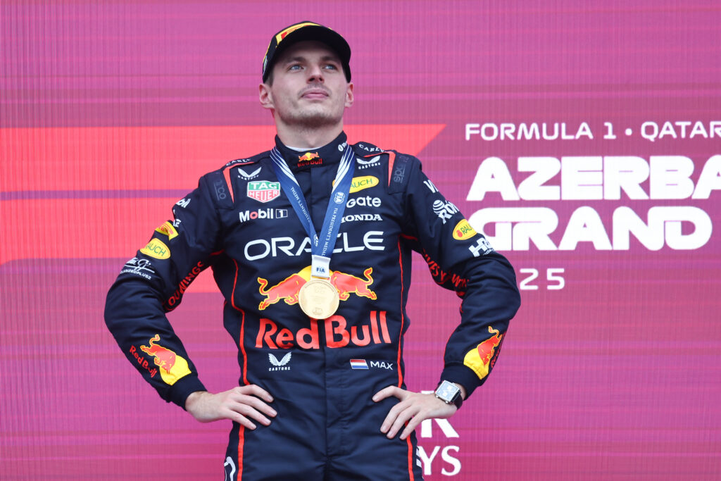 Red Bull driver Max Verstappen stands on the Baku podium after winning the 2025 F1 Azerbaijan Grand Prix