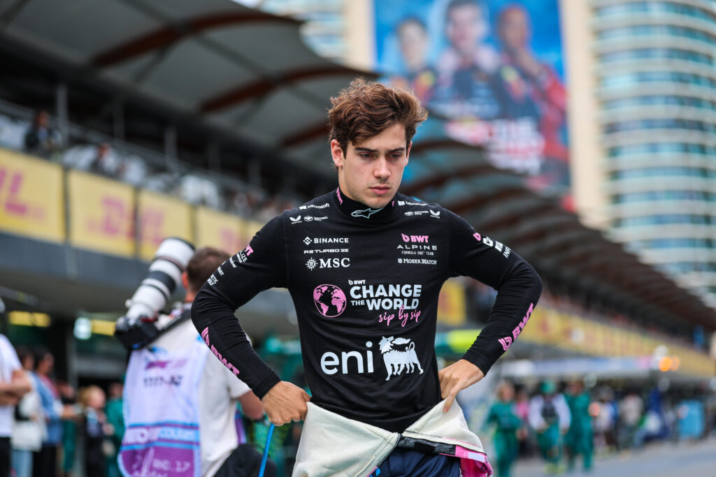 Alpine driver Franco Colapinto walking down the pit lane at the 2025 Formula 1 Azerbaijan Grand Prix