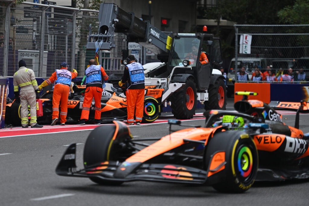 Lando Norris drives past the stricken McLaren of his teammate in Baku after Oscar Piastri crashed out of the 2025 F1 Azerbaijan Grand Prix