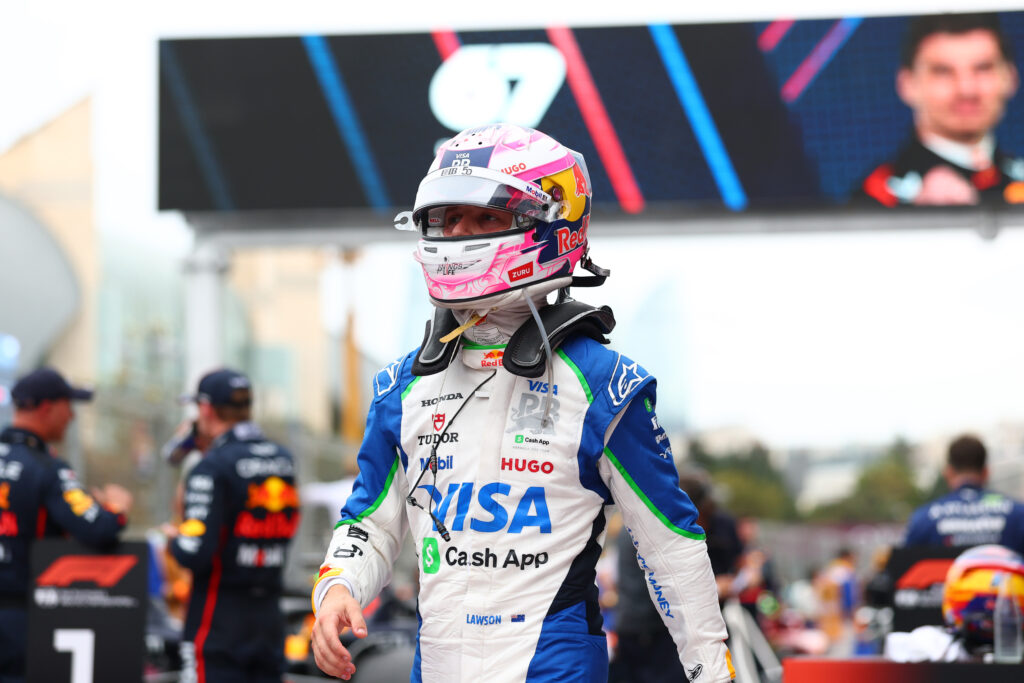 Racing Bulls driver wearing his helmet walking through the paddock after the 2025 Formula 1 Azerbaijan Grand Prix