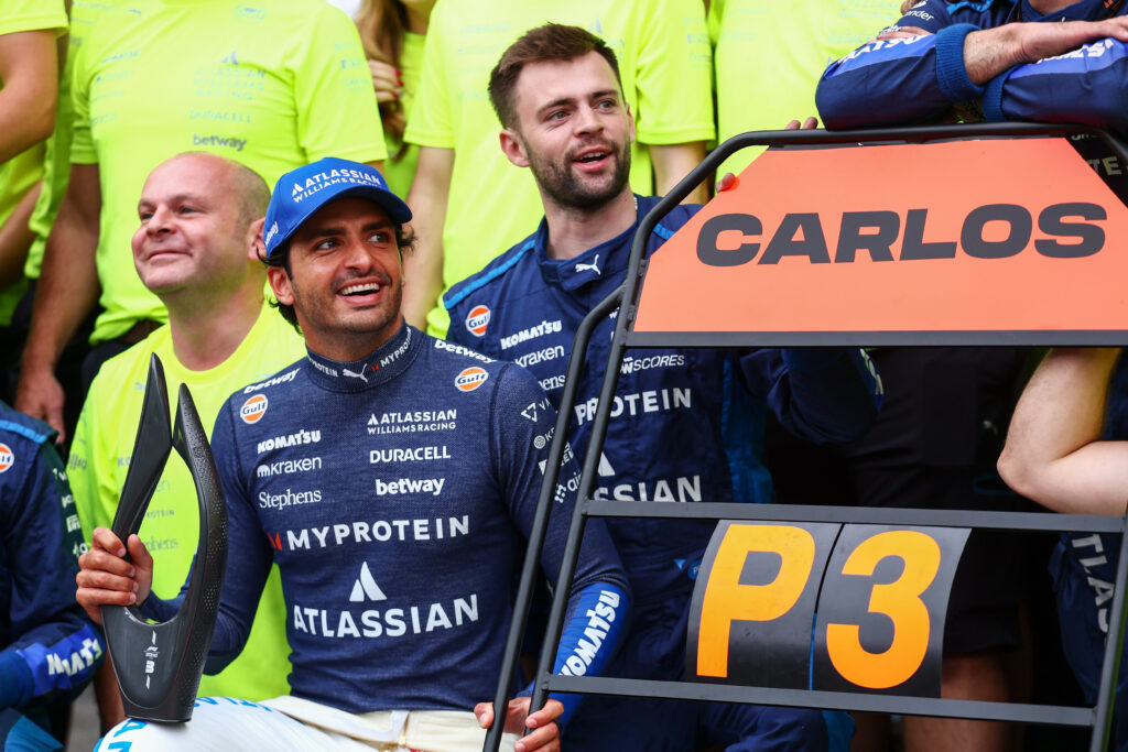 Williams driver Carlos Sainz Jr celebrates his podium in the 2025 F1 Azerbaijan Grand Prix with his team in the Baku pit lane
