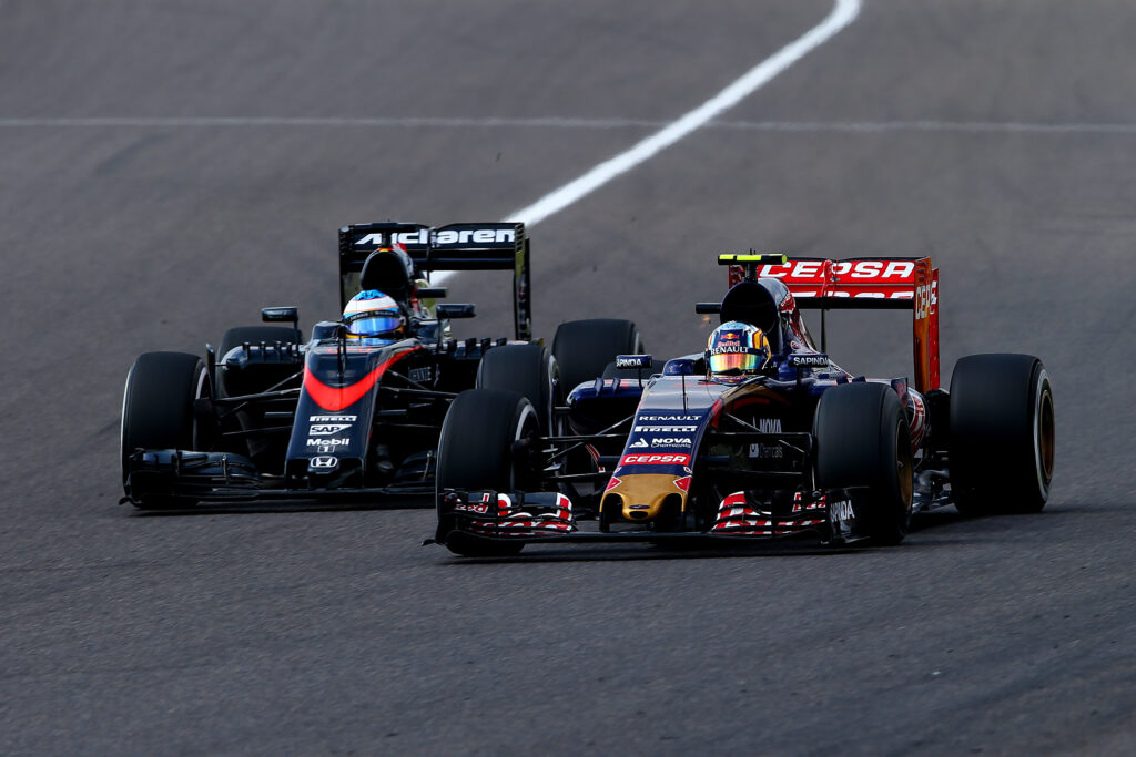 Fernando Alonso of McLaren gets overtaken by Carlos Sainz at thr 2015 Japanese Grand Prix