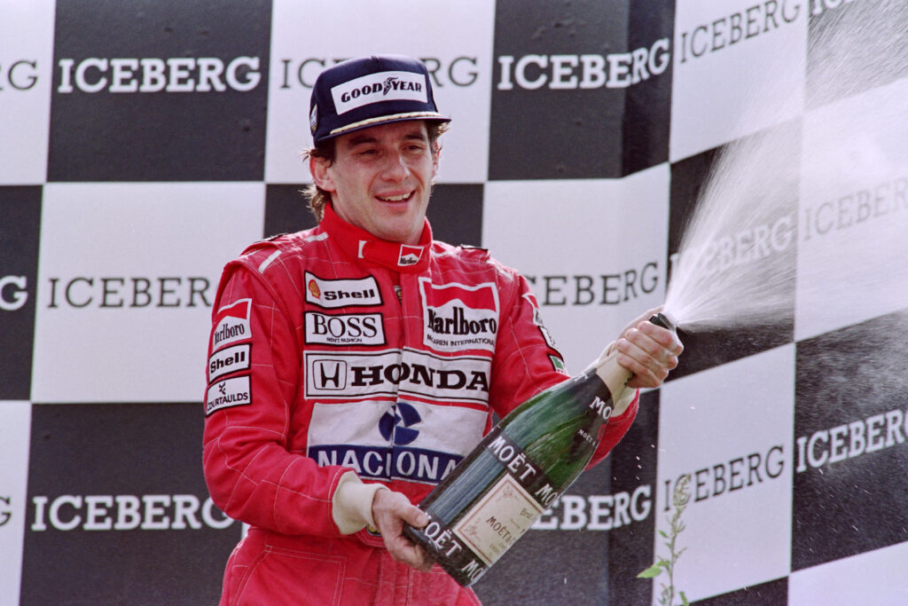McLaren driver Ayrton Senna sprays champagne from winners podiums after winning the Belgium Formula 1 Grand Prix in 1991