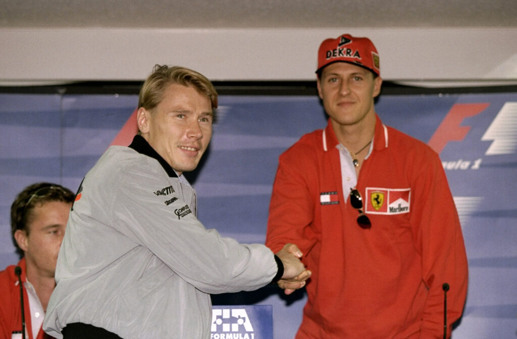 Mika Hakkinen and Michael Schumacher shaking hands ahead of their title showdown at the 1998 Japanese Grand Prix.