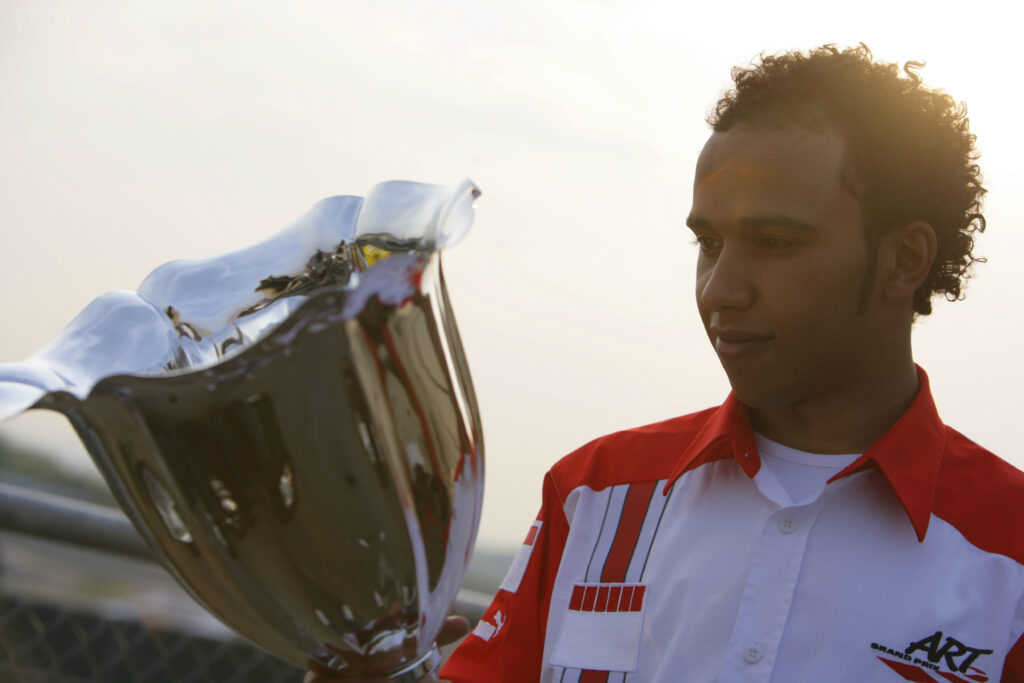 Lewis Hamilton stares at one of his GP2 trophies in 2006