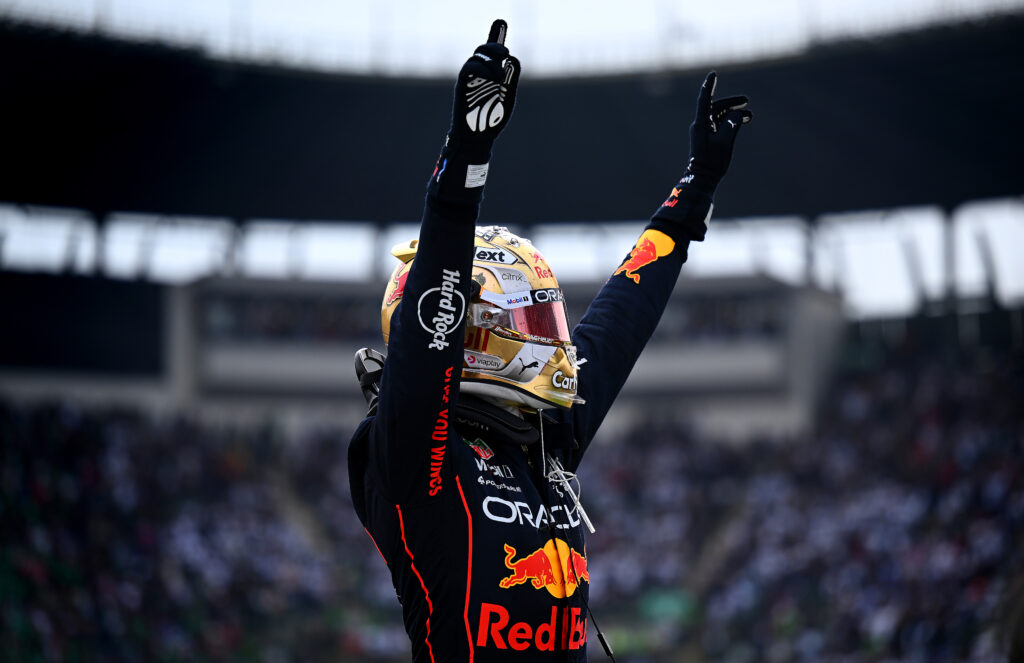 Max Verstappen celebrates with both hands in the air after winning the 2022 Mexican Grand Prix