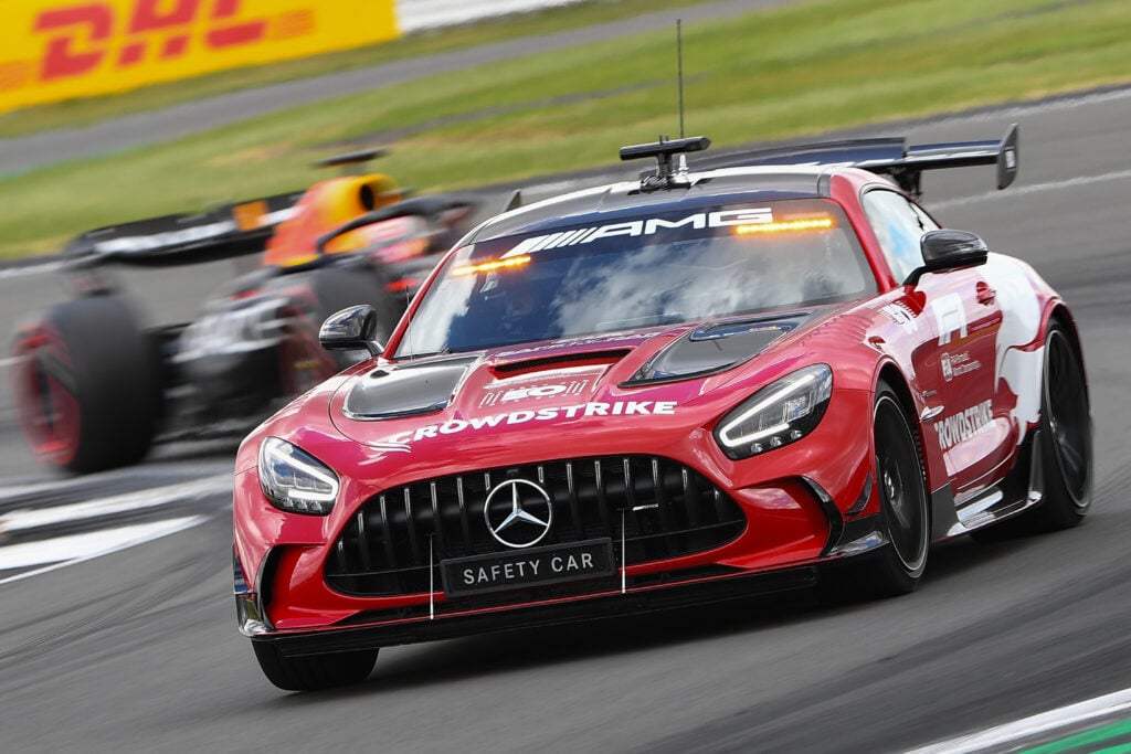 The Mercedes F1 safety leads a Red Bull car around Silverstone at the British Grand Prix