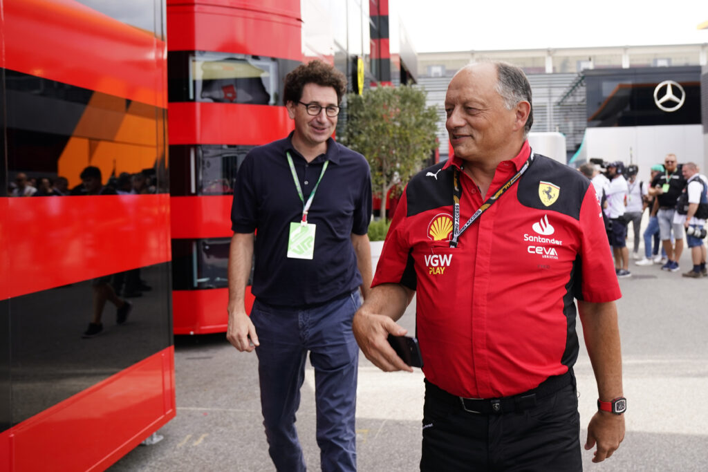 Ferrari team principal Frederic Vasseur walks through the Monza paddock with Mattia Binotto at the 2023 F1 Italian Grand Prix