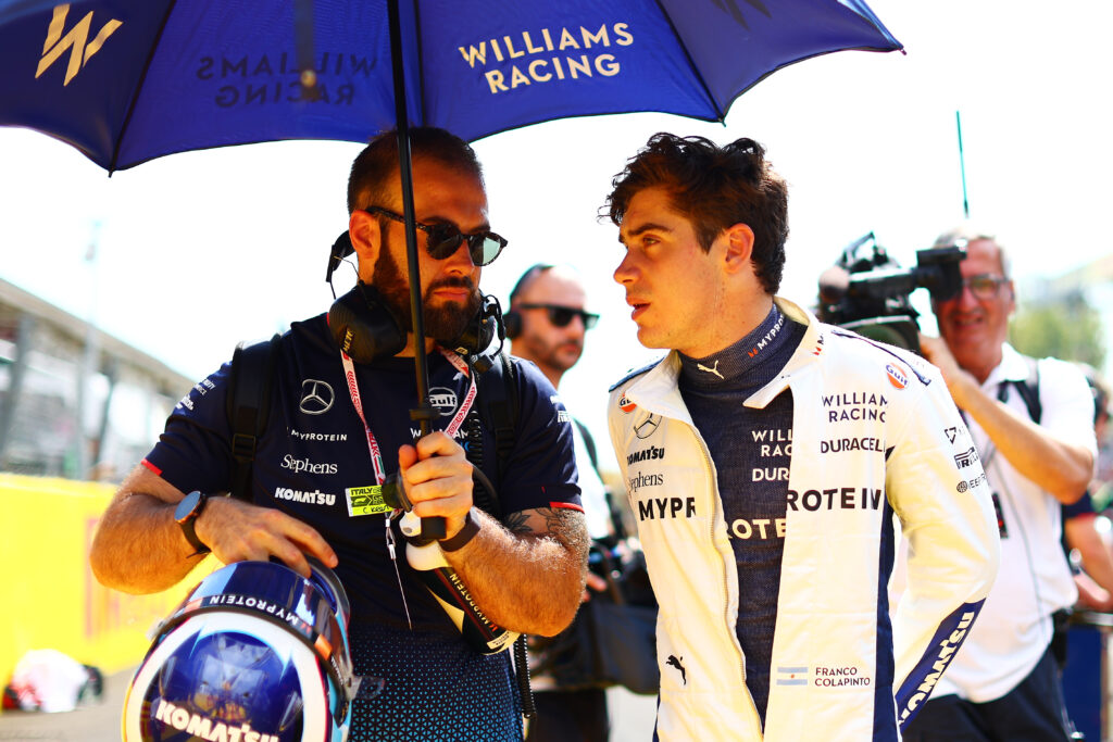 Franco Colapinto driving for Williams and talking to a member of staff ahead of his debut at the 2025 Formula 1 Italian Grand Prix