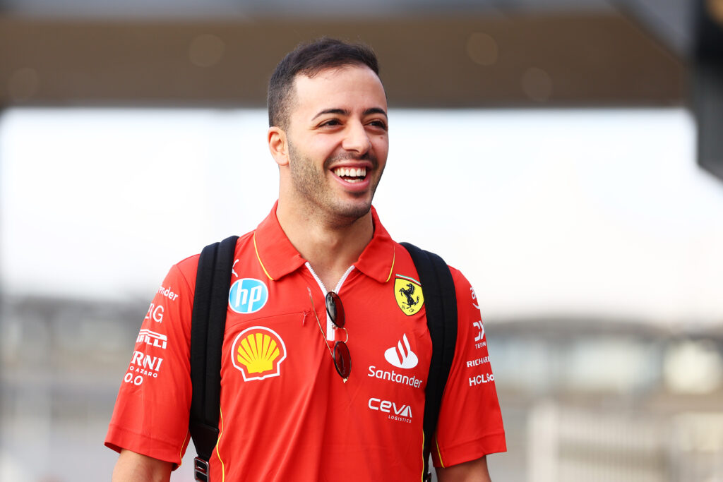 Antonio Fuoco smiles as he walks into the paddock ahead of his Ferrari Formula 1 test in Abu Dhabi