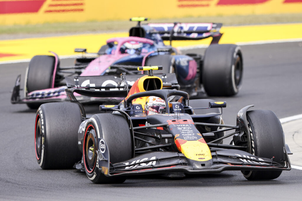 Yuki Tsunoda for Red Bull leads from Alpine's Franco Colapinto at the 2025 Hungarian Grand Prix