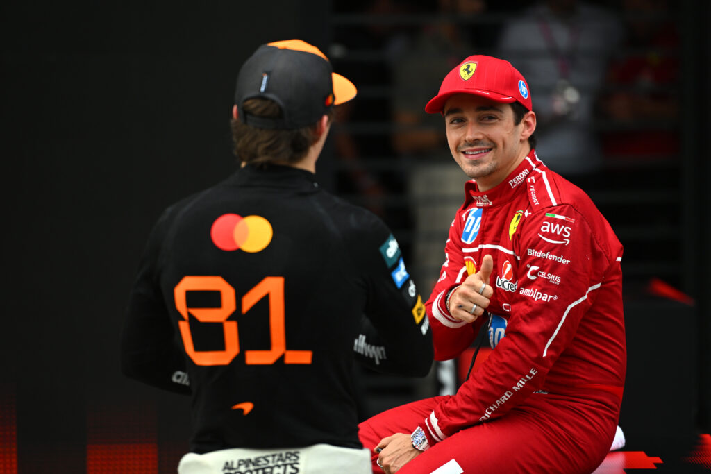 Ferrari driver Charles Leclerc speaks with McLaren's Oscar Piastri after qualifying for the 2025 F1 Hungarian Grand Prix