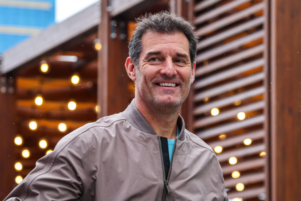 Oscar Piastri's manager Mark Webber walking through the paddock at the 2025 Formula 1 United States Grand Prix
