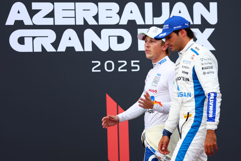 Carlos Sainz of Williams and Liam Lawson of Racing Bulls speak in parc ferme at the Azerbaijan Grand Prix