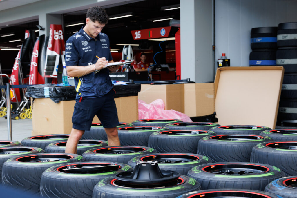 A Red Bull engineer preparing wet-weather Pirelli tyres at the 2025 Singapore Grand Prix