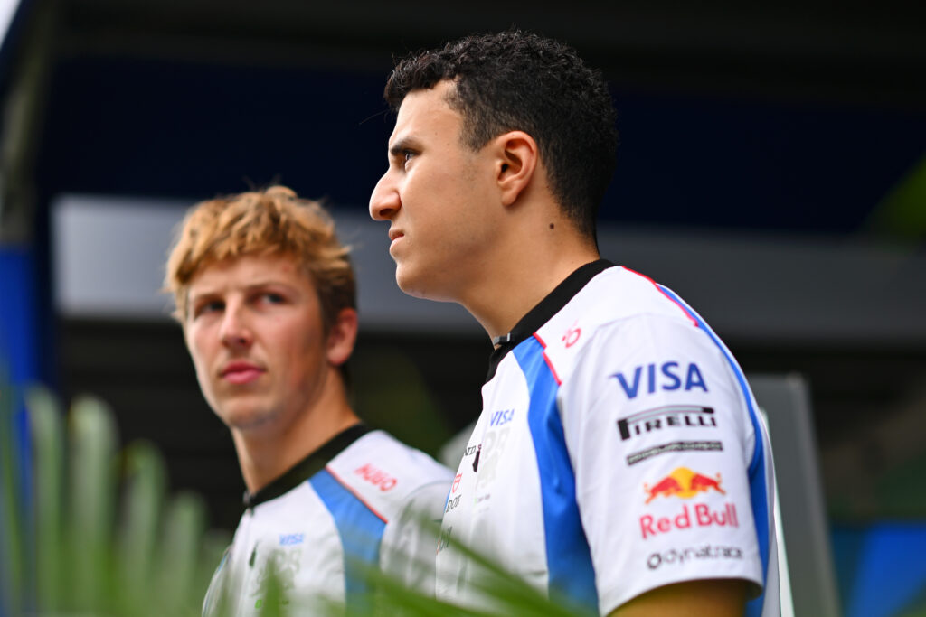 Racing Bulls drivers Isack Hadjar and Liam Lawson walk through the 2025 F1 Singapore Grand Prix paddock