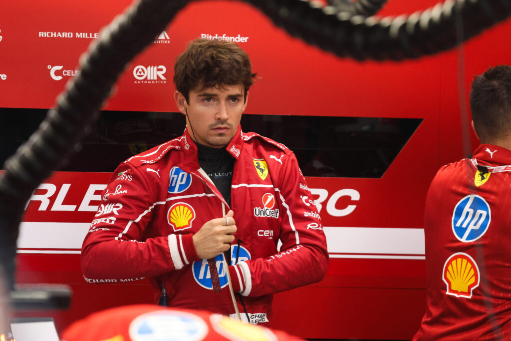 Ferrari driver Charles Leclerc adjusting his race suit ahead of qualifying at the 2025 Formula 1 Singapore Grand Prix