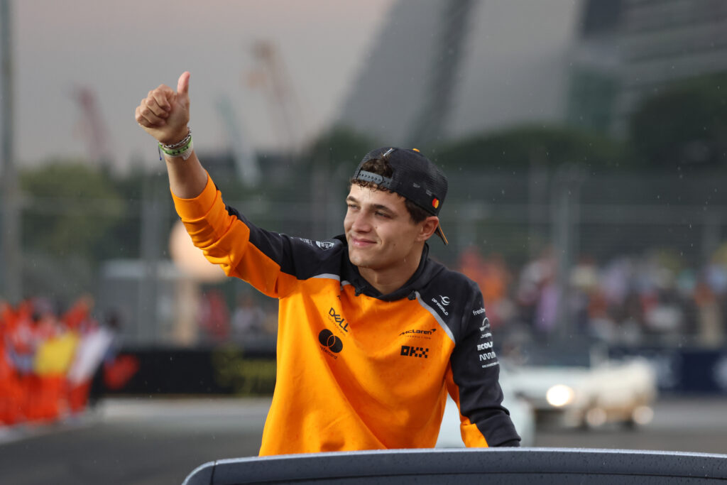 McLaren driver Lando Norris giving fans a thumbs up at the 2025 Formula 1 Singapore Grand Prix